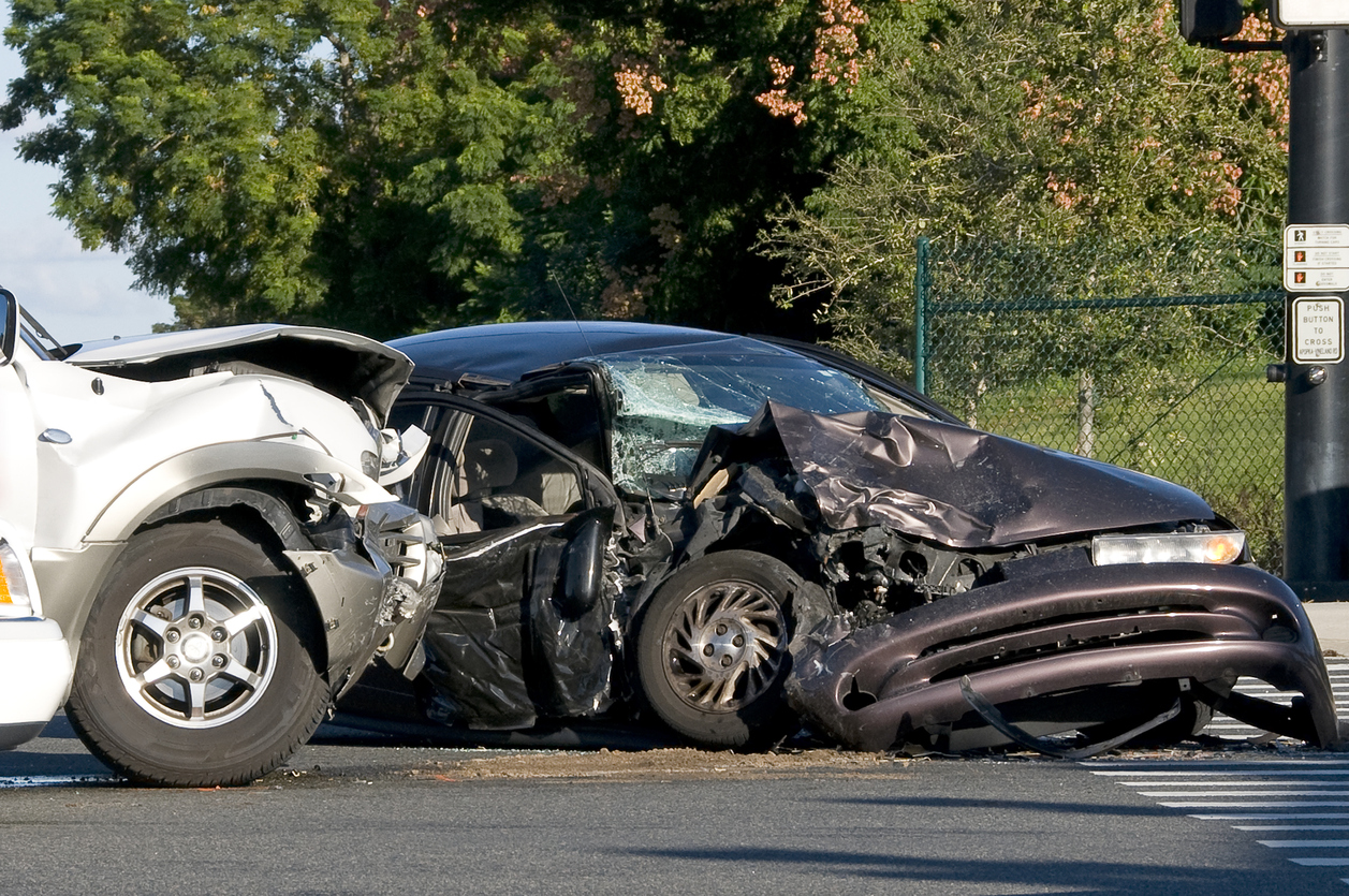 a silver car and a black car smashed up after a collision